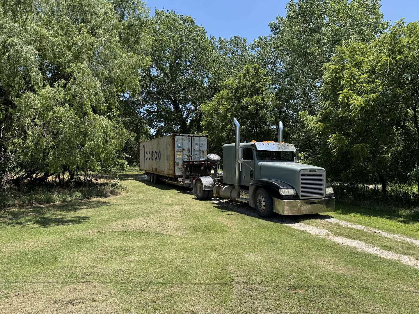 Truck hauling a COSCO 40 ft shipping container
